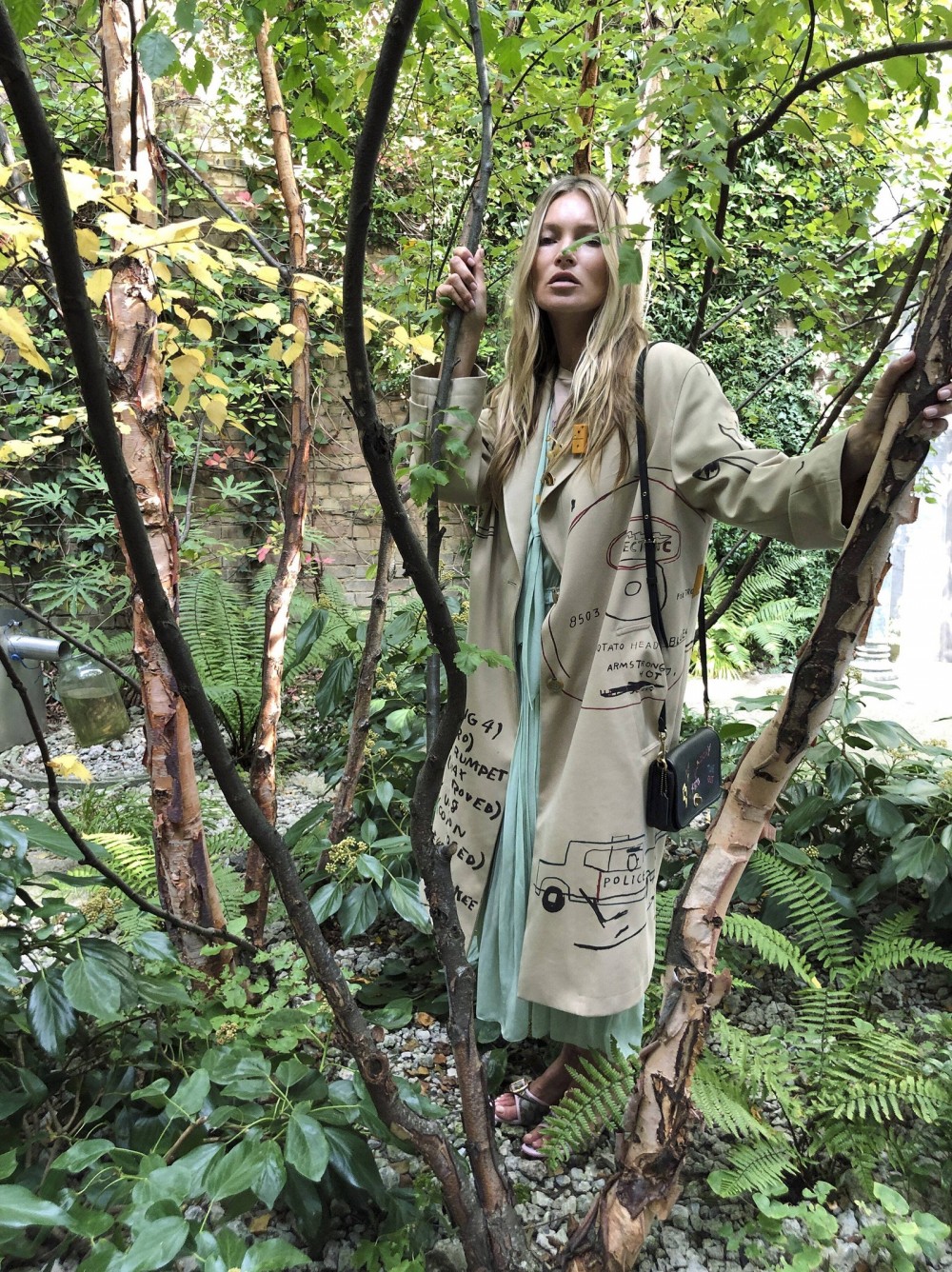 Kate Moss in a Coach x JeanMichel Basquiat trench from the fall 2020 collection restyled for spring 2021