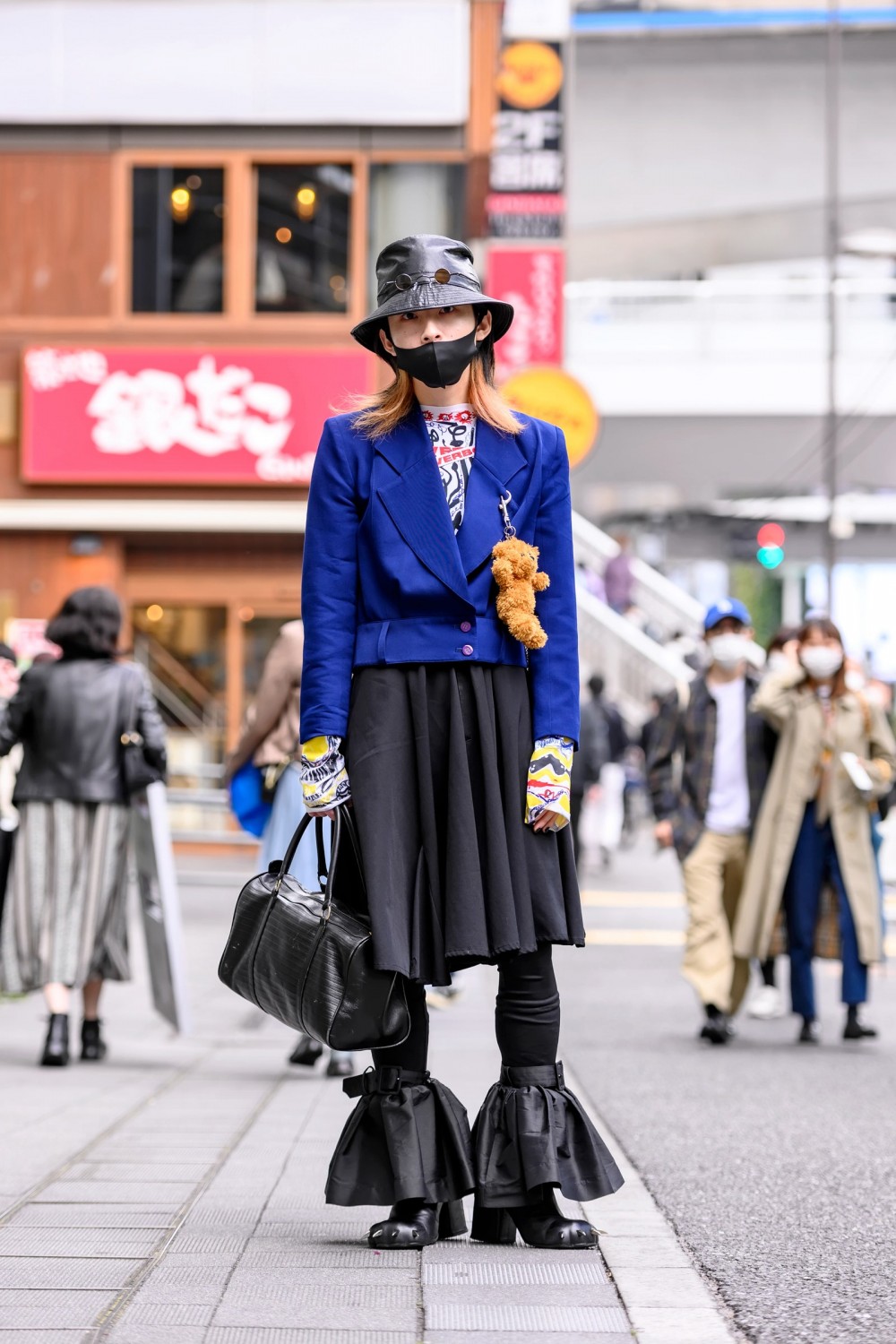 Image may contain Clothing Apparel Human Person Pedestrian Helmet Female Footwear Shoe Woman and Skirt